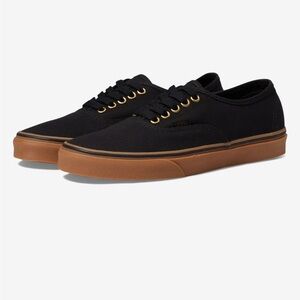 Black Vans with gold eyelet detail